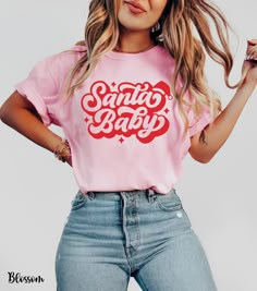 Get festive and flirty with our Santa Baby shirt, featuring "Santa Baby" in a cute retro font topped with an adorable Santa hat. This cozy Comfort Colors shirt is perfect for adding a playful touch to your holiday wardrobe. Whether you're heading to a Christmas party or just embracing the season's spirit, this Christmas Santa Baby tee is a must-have for women who love fun and stylish holiday looks. Perfect as a Christmas party shirt for women or a go-to pink Christmas Santa tee, it's the ultimat Santa Shirt Ideas, Fun T Shirts For Women Graphic Tees, Santa Baby Shirt, Pink Christmas Shirt Ideas, Holiday Tshirts Ideas, Baby Christmas Shirt, Santa Tshirt, Santa Tee, Christmas Party Shirts