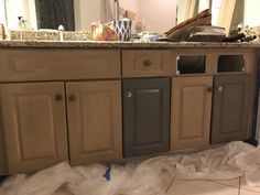 the kitchen cabinets are being painted brown and gray