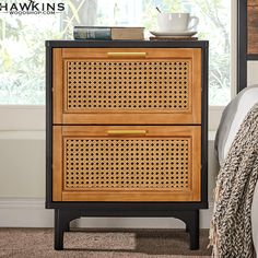 a nightstand with two drawers in front of a window