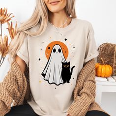 Vintage Halloween T-Shirt, Retro Ghost T-Shirt,Retro Halloween T-Shirt,Cute Ghost T-Shirt,Vintage Ghost T-Shirt,Gift for Women,Birthday Gift **Product Specifications**   We take pride in using only the highest quality brands for our printing, exclusively utilizing Bella Canvas and Gildan SoftStyle. *Bella Canvas*   - Available in unisex sizing   - Lightweight at 4.2 oz.   - Solid colors are made from 100% Combed and Ring-Spun Cotton.   - Athletic Heather contains 90% Combed and Ring-Spun Cotton, 10% Polyester.   - Heather CVC Colors are a mix of 52% Combed and Ring-Spun Cotton with 48% Polyester.   *Gildan SoftStyle*   - Unisex sizes available   - Sport Gray: 4.5 oz/yd² | 90% Ring-Spun Cotton / 10% Polyester   - Heather Navy, Heather Maroon, Heather Galapagos Blue, Dark Heather: 4.5 oz/yd² Halloween Novelty T-shirt With Graphic Print, Retro Halloween T-shirt With Character Print, Vintage Halloween T-shirt With Letter Print, Vintage Crew Neck Halloween Tops, Vintage Crew Neck Tops For Halloween, Halloween Funny Print Graphic T-shirt, Halloween Graphic Tee With Funny Print, Vintage Halloween Tops With Character Print, Vintage Halloween Character Print Top