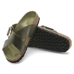 a pair of women's sandals with buckles on the front and back straps