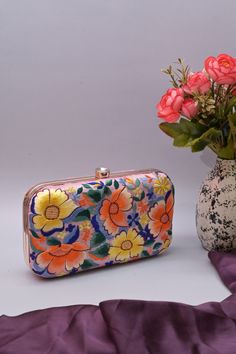 The excellent hand Parsi gara embroidery work is done on this clutch bag which you can use as a clutch and a sling with a long handle. It comes with a small and a big shoulder strap. It has one main compartment with a click closure. Carry this bag this festive season and look glamorous. Team this up with ethnic wear for a fashionable look. Color: Pink Size & Fit: Length: 8 inch Width: 2 inch Height: 5 inch Material: Silk Care: Wipe with a dry cloth Luxury Zari Work Shoulder Bag For Party, Luxury Elegant Shoulder Bag With Zari Work, Elegant Luxury Shoulder Bag With Zari Work, Luxury Festive Shoulder Bag With Zari Work, Luxury Zari Work Shoulder Bag For Festive Occasions, Multicolor Embroidered Evening Clutch Bag, Evening Multicolor Embroidered Bag, Embroidered Multicolor Clutch For Evening, Party Multicolor Clutch With Removable Pouch