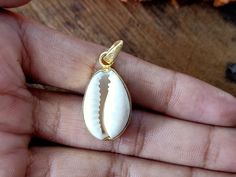 Handmade Cowrie Shell bohemian pendant Title -Cowrie Shell pendant Stone color - White Material - Sterling silver 925 we are giving you best quality rings on best price .. contact us for more quantity Handmade Round Pendant Jewelry For Beach, Spiritual Gold Shell-shaped Jewelry, Artisan Gold Beach Jewelry, White Bohemian Necklace With Charms, Artisan Jewelry With Moon Charm For Gift, Artisan Jewelry With Moon Charm As Gift, Spiritual Gold Shell Jewelry, Bohemian White Charms Necklace, Artisan Gold Jewelry For Beach