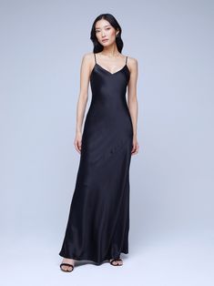 An effortlessly elegant gown length maxi slip dress. A clean v-neckline hangs from adjustable spaghetti straps. Black charmeuse silk skims over curves, creating a slinky silhouette. 100% Silk. Black Tie Affair, Maxi Slip Dress, Gowns Of Elegance, Premium Denim, Clothes Collection, Black Tie, Dress Materials, Spaghetti Strap, Jumpsuit Dress