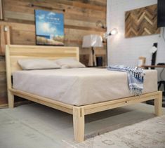 a bed that is made up with wooden headboard and foot board in a room