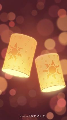 two yellow lamps with hearts and sun designs on them