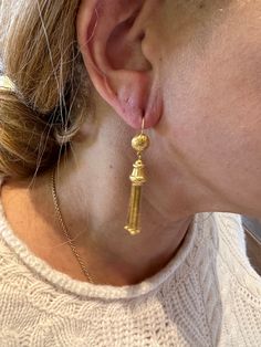 The Etruscan revival period of the late 1800s was inspired by the findings of archaeological digs in and around Rome. The Etruscans inhabited the area before the Romans did! The ancient jewelry being found was marked by gold granulation, filigree, and classical cultural themes. These Etruscan revival earrings were likely made at the tail of the 19th century and have a group of gold tassels suspended from a floral themed gold finial. The tassel and finial are suspended from a half sphere that's e Traditional 14k Gold Drop Earrings, Historical Yellow Gold Drop Earrings, Yellow Gold Historical Drop Earrings, Traditional Yellow Gold Earrings With Historical Design, Yellow Gold Drop Earrings With Historical Design, Antique Yellow Gold Ceremonial Earrings, Antique Gold Earrings With Historical Design, Victorian 22k Yellow Gold Jewelry, 22k Gold Victorian Ceremonial Jewelry