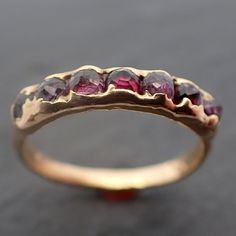 Wedding Band 18k Gold byAngeline 3418 One of a kind wedding band for a one of a kind person. I hand carve these bands in wax and cast the rubies in place. Each is one of a kind coming up out of the gold. This is a premade band in size 5.5 and it can be resized a bit. This band is about 2mm wide and about 4mm around the stones. If this band cannot be resized to fit you, ask about making one in your size. Throughout all of time and history, and in every tribe and culture all around the world cryst Gold Band Wedding Ring, Ruby Bands, Kind Person, Minerals And Gemstones, Metal Clay, Multi Stone, Gold Band, Gold Bands, Wedding Band