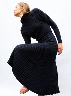 This long, fine knit dress, made in France and slightly fitted at the waist, is a must-have item in the Molli winter wardrobe. The generous fullness that unfurls from its discreet, elegant waistband will flatter any silhouette. It features a high collar and its bodice is knit in a delicate, subtle, feminine herringbone stitch. In a “midnight” color, this timeless knit dress, a wardrobe staple, is easy to wear year-round, either accessorized in summer with gold jewelry or worn with leather boots Midnight Color, Pleated Knit, Herringbone Stitch, Must Have Items, High Collar, Winter Wardrobe, In Summer, Herringbone, Wardrobe Staples