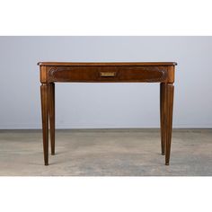 an antique wooden table with drawers on one end and a drawer on the other side