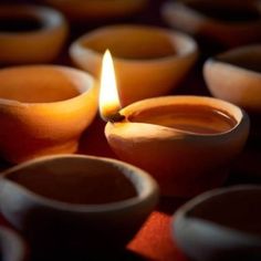 several clay bowls with a lit candle in the middle