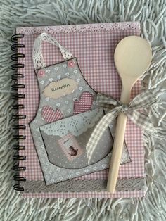 a wooden spoon sitting on top of a notebook