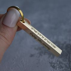 a woman's hand holding a gold ring that says, happy birthday with an inscription on it