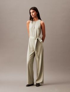 Solid Sleeveless Jumpsuit Elegant Belted Jumpsuits And Rompers For Summer, Chic Belted Strapless Jumpsuit For Work, Fitted Belted Sleeveless Jumpsuits And Rompers, Sleeveless Belted Jumpsuit For Formal Occasions, Formal Belted Sleeveless Jumpsuits And Rompers, Sleeveless Belted Formal Jumpsuits And Rompers, Sleeveless Belted Formal Jumpsuit, Chic Spring Pantsuit With Tie Waist, Chic Sleeveless Jumpsuits And Rompers With Tie Waist