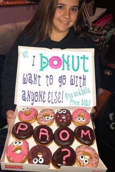 a girl holding up a box of donuts that say i donut want to go with anyone else