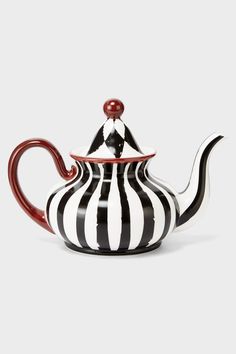 a black and white striped teapot with a red top on the side, sitting in front of a gray background