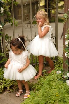 Dress your little princess in the Mini Fairy Garden Dress in White, a whimsical ensemble designed for enchanting adventures. Featuring a square neckline and cap-length ruffle sleeves, this dress boasts a knee-length skirt with a delicate crinoline underlay for extra flair. Complete with a hidden back zipper and a comfortable smocked back detail, it’s perfect for twirling through fairytale realms and making magical memories. Fairy Garden Dress, Thanksgiving Dress, Mini Fairy Garden, Baby Fairy, Garden Dress, White Dress Party, Holiday Party Dresses, Dreamy Dress, Girls Dresses Summer