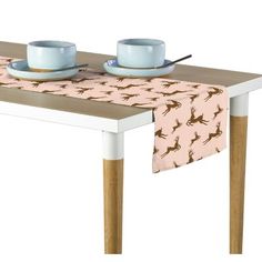 a table with two cups and saucers on it