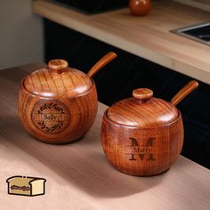 two wooden salt and pepper shakers on a counter