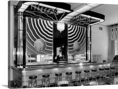 an old photo of a bar with chairs and stools in the middle of it