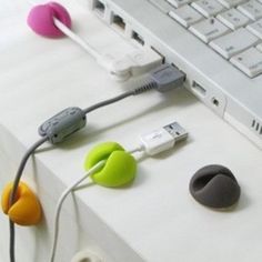 an assortment of headphones are plugged into a laptop computer's external keyboard