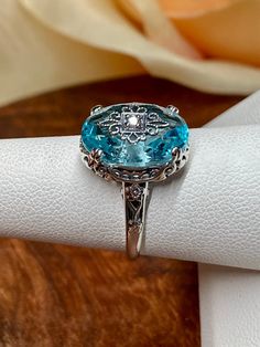 Exquisite Topaz Ring With Diamond Accents, Turquoise Sapphire Ring With Accent Stones For Anniversary, Turquoise Sapphire Anniversary Ring With Accent Stones, Classic Crystal Ring With Gemstone Accents For Anniversary, Dazzling Diamond Ring With Gemstone Accents For Wedding, Formal Aquamarine Ring With Diamond Accents, Turquoise Sapphire Ring With Accent Stones, Fine Jewelry Turquoise Sapphire Ring With Accent Stones, Classic Topaz Gemstones With Accent Stones