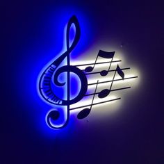 a lighted sign with musical notes on it's side and blue light in the background