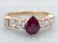 Add some sparkle to your life with this ring! Featuring a stunning pear cut ruby and diamond accents, this yellow gold ring is perfect for any occasion. Shine bright with this unique piece that will definitely turn heads! Metal: 14K Yellow GoldGem: Ruby 1.08 CaratsGem Measurements: 5.5 x 7.3 mm, Pear CutAccents: 6 Diamonds totaling .82 Carats, SI in Clarity, G-H in ColorRing Size: 7Marks: "14K" Stamped on the inside band Pear-shaped Ruby Diamond Ring With Prong Setting, Diamond Ruby Ring With Prong Setting In Pear Shape, Pear-shaped Ruby Ring With Diamond, Red Ruby Ring With Brilliant Pear-shaped Cut, Red Pear-shaped Ruby Ring With Brilliant Cut, Pear-shaped Brilliant Cut Yellow Gold Ruby Ring, Yellow Gold Pear-shaped Ruby Ring With Center Stone, Pear-shaped Yellow Gold Ruby Ring With Center Stone, Pear-shaped Ruby Ring In Yellow Gold With Center Stone