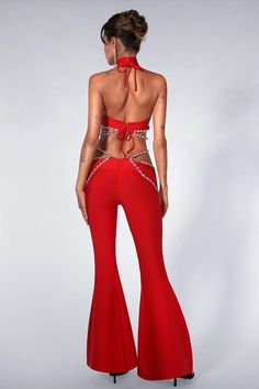 the back of a woman's red evening gown with high waist and open slits