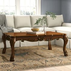 a living room with a white couch and wooden coffee table