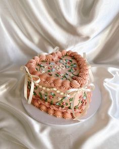 a heart shaped cake with pink frosting and sprinkles