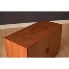 a wooden cabinet sitting on top of a hard wood floor