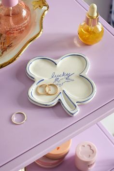 a close up of a plate with a flower on it and two rings sitting next to each other