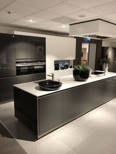 a modern kitchen with stainless steel appliances and counter tops