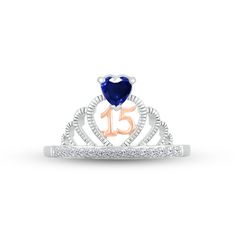 a diamond and blue heart ring with the number fifteen on it's front side