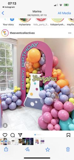 an image of a birthday party with balloons on the wall and cake in the middle