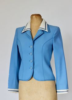 1960s Light blue suit wool jacket with beautiful details. White collar and cuffs. Closure with 4 buttons plus one spare ( all original) neatly still attached inside the jacket 2 Belt loops. Label: Ralph Creation, Germany Fabric: Pure New Wool  Fully lined: Viscose 100%   Estimated Size EU 36-38  - US 8, UK 12, please check measurements. The measures have been taken with the item flattened out (double bust and waist).  Arm pit to arm pit: 42 cm - 16,53 inches Waist  37 cm - 14,56 inches Length bag:  55 cm - 21,65 inches Sleeves:  57 cm - 22,44 inches Very good vintage condition. One tiny spot on the right side near the collar (see photo)  and pale yellowing inside the collar along the neck.  Follow us on Instagram @by_waltz https://www.instagram.com/by_waltz/ Vintage Formal Blazer With Button Cuffs, Blue Wool Blazer With Button Cuffs, Fitted Blue Blazer With Button Cuffs, Vintage Blue Blazer For Workwear, Fitted Retro Blue Blazer, Retro Fitted Blue Blazer, Vintage Blue Blazer With Notch Lapel, Vintage Blue Blazer With Button Closure, Vintage Blue Blazer For Formal Occasions