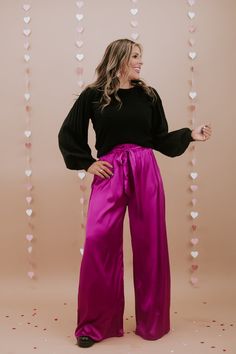 Unveil elegance with our "Best For Last" Satin Pants in Magenta. These luxurious pants exude sophistication with their smooth satin finish and vibrant magenta hue. Perfect for making a bold fashion statement at special events or elevating your everyday style. Date Night outfit inspo Waistband: High rise Fabric: 95% Polyester, 5% Spandex Sleek satin fabrication Adjustable tie belt waistband Wide leg bottom Imported Fit: True to size!- Waist: Elastic/High rise- Leg: Wide leg - Stretch only in wais Elegant Pink Satin Bottoms, Chic Satin Finish Bottoms For Party, Chic Bottoms With Satin Finish For Party, Chic Party Bottoms With Satin Finish, Pink Stretch Satin Bottoms, Elegant Pink Bottoms With Elastic Waistband, Elegant Purple Pants For Party, Elegant Satin Pants For Fall, Elegant Purple Bottoms For Party