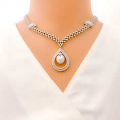 This exquisite 18k gold set, weighing 69.6 grams, features a stunning combination of diamonds and pearls, exuding luxury and sophistication. The yellow gold finish beautifully complements the sparkling diamonds and elegant pearls, making it perfect for any special occasion. The set includes a necklace adorned with 11.25 carats of F-G color, VS quality diamonds, and 24.87 carats of pearls. The necklace's length and drop length details are unspecified, but it is secured with a hook lock. The match Luxury White Pear-shaped Diamond Necklace, White Diamond Necklace For Evening, Fine Jewelry, White Diamond Necklace For Evening, Luxury Diamond White Bridal Necklace, Wedding Pearl White Necklace With Diamond Accents, Luxury White Diamond Necklace With Pearl Chain, Luxury Pear-shaped Diamond White Necklace, Luxury Pear-shaped Diamond Bridal Necklace, White Brilliant Cut Jewelry For Evening