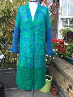 All year women's knit long sleeves sweater. Very light weight, warm and cosy hand knitted mohair cardigan, made from green and sky blue mohair mixtures: 78% mohair, 13% wool, 9% nylon. Made in England.  The length approx. 112cm, 44 inches. One size will fit size S-XL. Gift idea for wife, mum or mother in law. Warm hand wash, cold rinse well, dry flat in shade. Winter Green Knitted Cardigan, Green Knitted Winter Cardigan, Green Long Sleeve One Size Cardigan, One Size Green Long Sleeve Cardigan, Winter Green Chunky Knit Cardigan, Green Knitted Sweater Coat For Winter, Green Chunky Knit Winter Cardigan, Green Cozy Acrylic Outerwear, Hand Knitted Mohair Cardigan For Winter