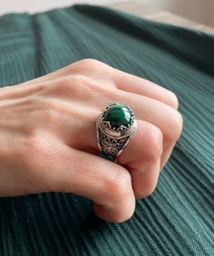 "Malachite Gemstone 925 Sterling Silver Artisan Made Handcrafted Filigree Art Statement Ring Ring Face Length is 0.55\" Natural Malachite Gemstone is 12 mm round cabochon cut. This metal embroidery filigree ring is oxidized and highly polished. Comes with velvet pouch and luxurious gift box. Filigree is made of delicate metal strands that have been skillfully fashioned to create an outstanding combination of old and modern art. Originating in Mesopotamia, Anatolia. It is made of delicate metal s Elegant Malachite Ring Jewelry, Emerald Filigree Ring Gift, Emerald Ring With Filigree For Gift, Round Emerald Ring With Filigree For Gift, Round Emerald Ring With Filigree As Gift, Elegant Malachite Gemstone Ring, Sterling Silver Spiritual Filigree Ring, Handmade Green Jewelry With Round Stone, Elegant Malachite Ring As Gift