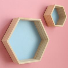 two wooden hexagons on a pink background