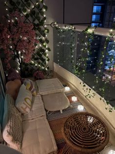 the balcony is decorated with lights and pillows