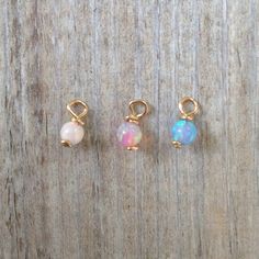 ♥ Please choose your SINGLE charm ♥ Wire wrapped 3mm lab opal bead WHITE (1) / PINK (2) / BLUE (3) Please choose your option for SINGLE charm: 1 - WHITE 2 - PINK 3 - BLUE Please choose material: ★100% 14K gold filled ★ ★100% Silver Sterling ★ ♥Please note - sold individually, not in pairs. Enter my shop here: https://www.etsy.com/people/junelana?ref=si_pr Tiny Dainty Opal Jewelry, Dainty Tiny Opal Jewelry, Tiny Charms, Hoop Charms, Tiny Charm, Locket Charms, Nose Ring Stud, Beaded Hoops, Pink Opal