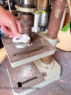 a man is using a drill machine to make something out of some kind of material