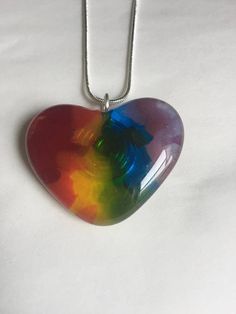 Handmade glass rainbow heart necklace on silver chain. This adorable fused heart pendant is perfect for any girl or teen's wardrobe. I made this heart using glass frit, which are fine glass particles. I formed red, orange, yellow, blue, green and purple glass into stripes to make a beautiful rainbow! Any kid would love this necklace. This heart necklace hangs from an 18 inch silver plated chain. I can change the chain size upon request. NOTE: Since my pieces are handmade, no two will look exactly alike or exactly like the photo. IMPORTANT: I make my jewelry as safe and secure as possible, but it is recommended that my pieces be kept away from younger children as there are small parts. Rainbow Heart Beads Jewelry Gift, Rainbow Heart Beads Jewelry For Gift, Gift Rainbow Jewelry With Heart Beads, Colorful Fun Necklaces For Gifts, Fun Colorful Necklaces For Gifts, Multicolor Hypoallergenic Necklace As A Gift, Multicolor Hypoallergenic Necklace For Gift, Hypoallergenic Multicolor Necklace Perfect As Gift, Hypoallergenic Multicolor Necklace For Gift