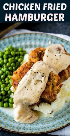 chicken fried hamburger on mashed potatoes with gravy and peas