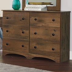 a wooden dresser with a mirror on top of it