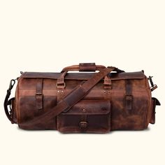 Dark oak buffalo leather duffle bag with adjustable shoulder strap, top handles, and secure buckle closures for travel. Leather Duffle Bag Men, Buffalo Jackson, Leather Briefcase Bag, Leather Holdall, Waxed Canvas Bag, Large Travel Bag, Leather Duffel Bag, Leather Weekender, Leather Duffel