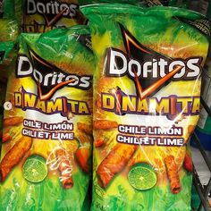 two bags of doritos dynamite chilli lime chips sitting on a shelf in a store